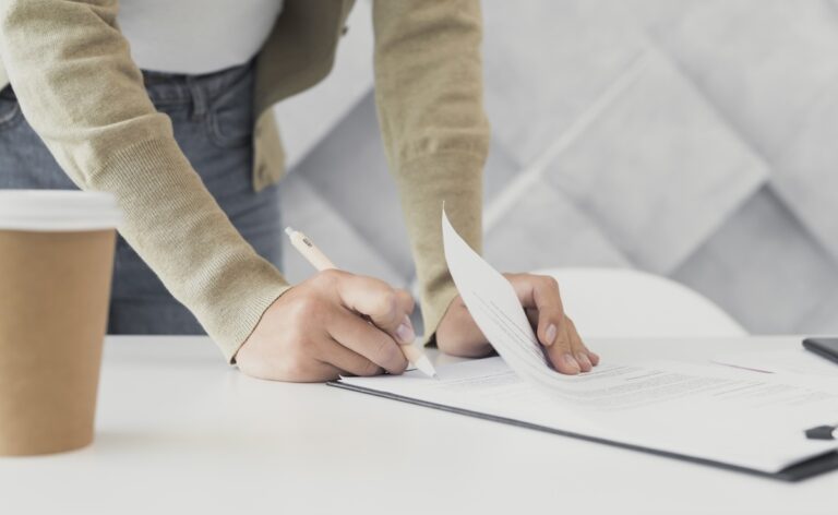 What is contract management - woman-signing-paper-close-up